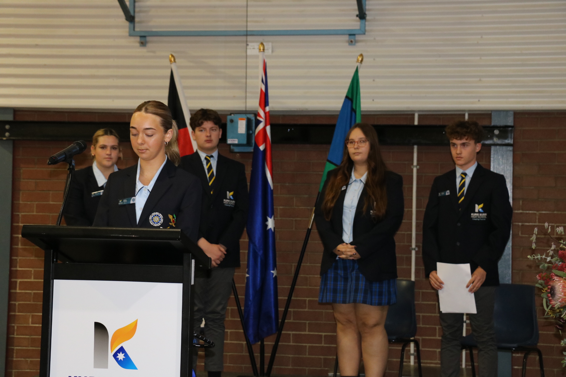 Student leaders speaking at an assembly.