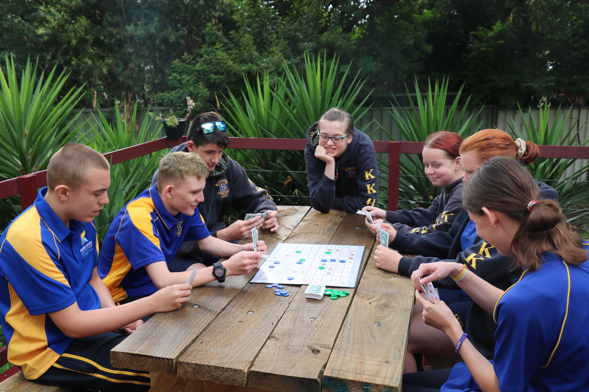 Students sitting around a table playing a game.